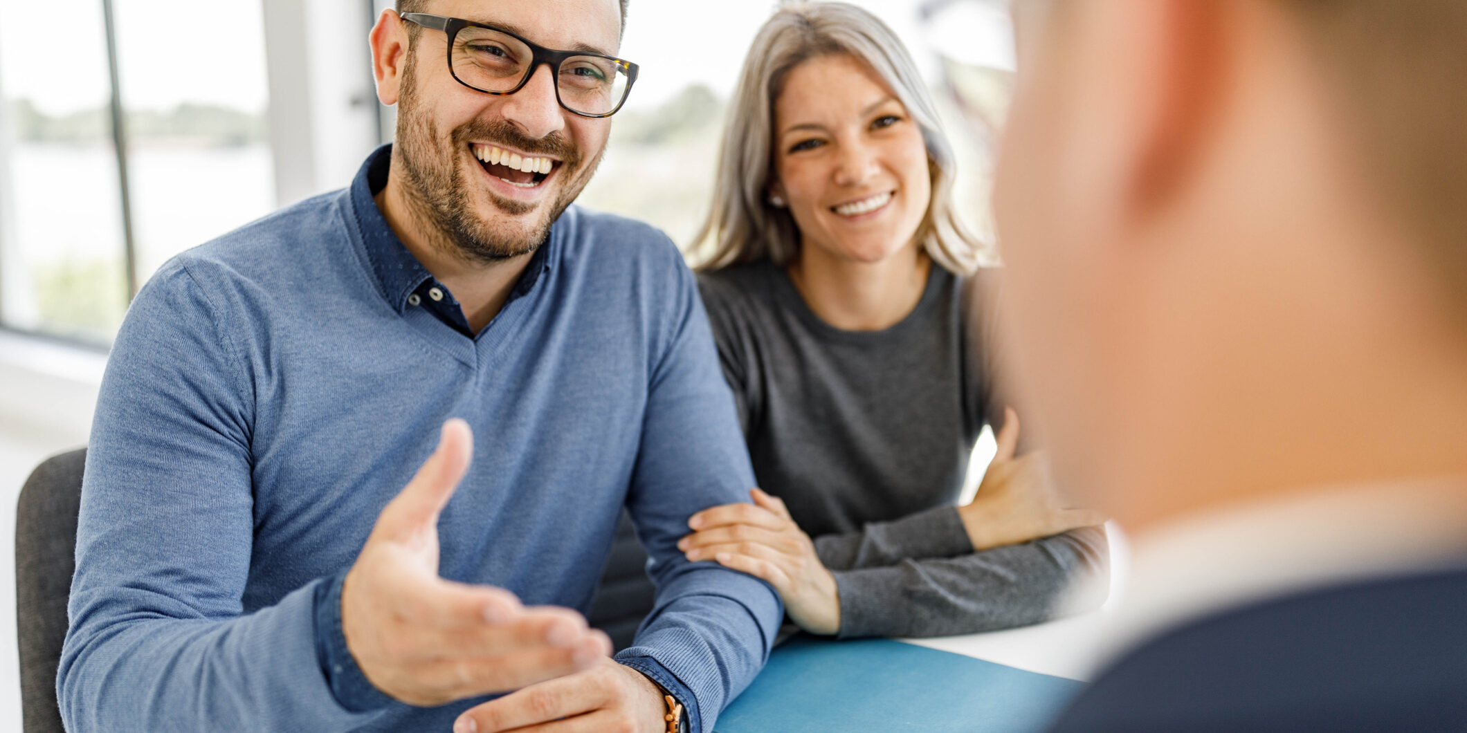 Happy couple talking to their bank manager on a meeting in the office. Financial Planning Meeting