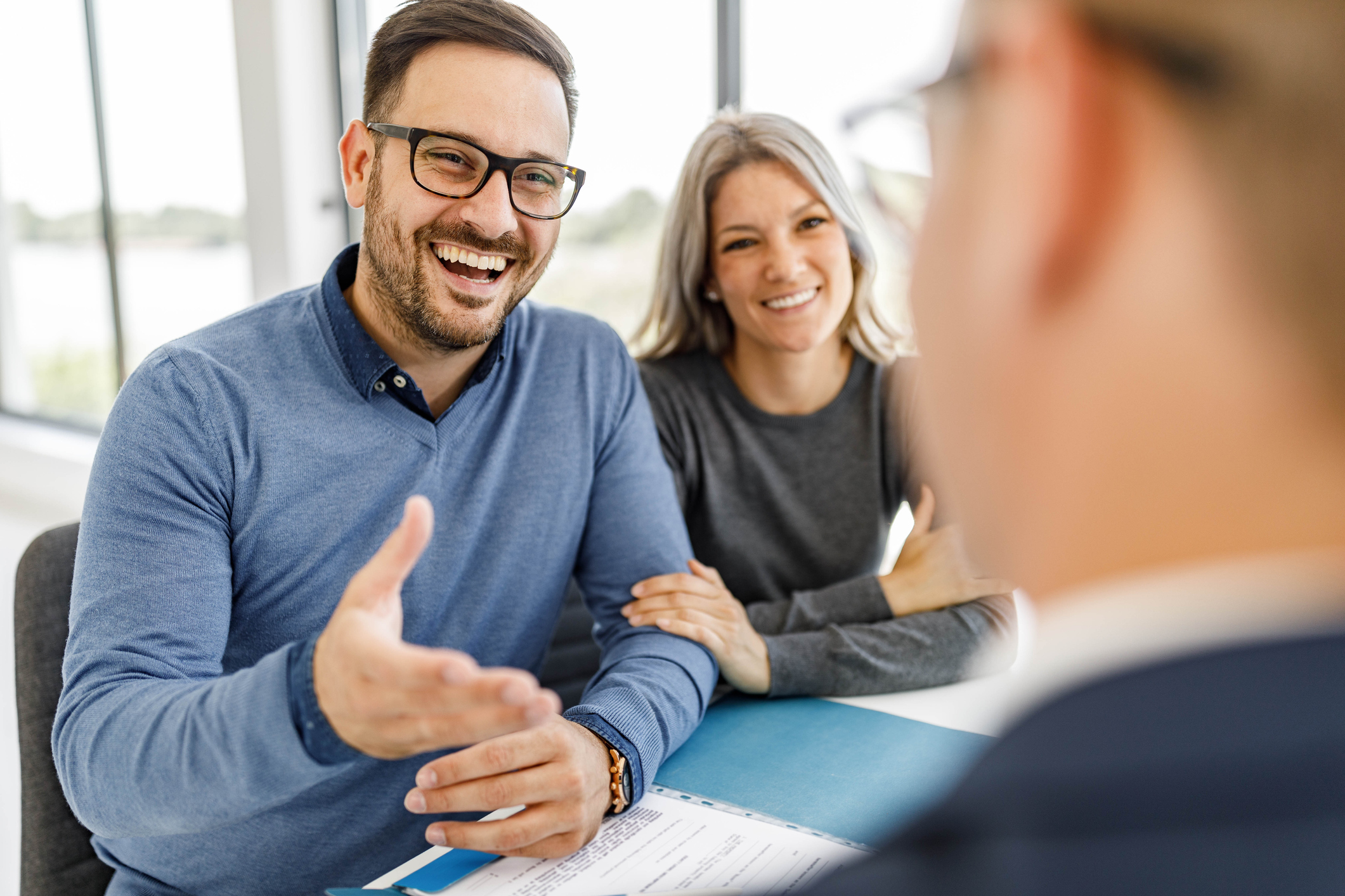 Happy couple talking to their bank manager on a meeting in the office. Financial Planning Meeting